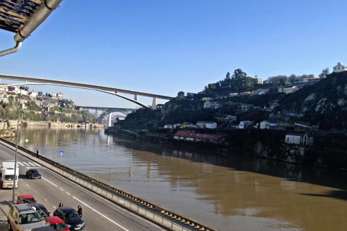 a train crossing a bridge over a river at RVA - Gustave Eiffel Apartments in Porto