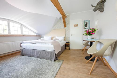 a bedroom with two beds and a table and a chair at Design Apartments - "Im Holländerviertel" in Potsdam