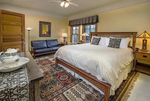 a bedroom with a large bed and a couch at McCloud Hotel in McCloud