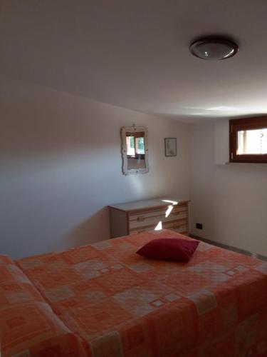 a bedroom with a bed and a desk and a window at CASAMARTY in San Cesareo