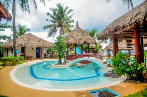 a swimming pool at a resort with a slide at Camaya-an Paradise Beach Resort in Malabugas