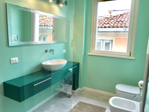 a bathroom with a sink and a mirror at Iseo Vista Lago in Iseo