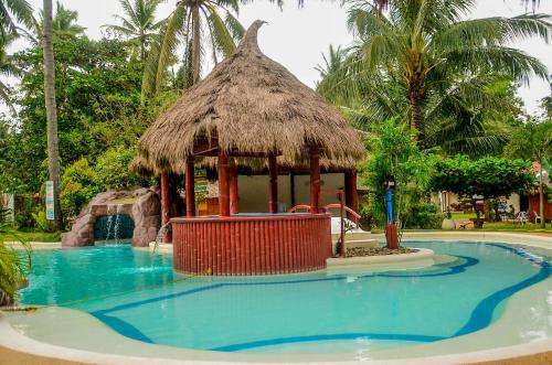 a swimming pool with a gazebo in a resort at Camaya-an Paradise Beach Resort in Malabugas