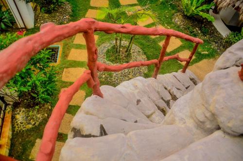 a set of red railings on a stone stairs at Camaya-an Paradise Beach Resort in Malabugas