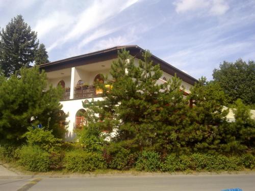 a white house with trees in front of it at Studánka in Orlová