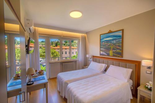 Postel nebo postele na pokoji v ubytování Hotel Lidò
