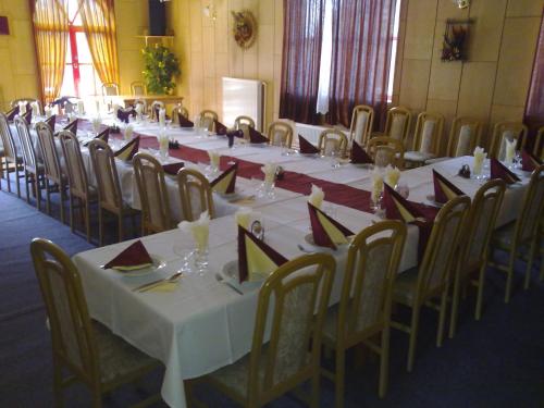 a group of tables and chairs in a room at Studánka in Orlová