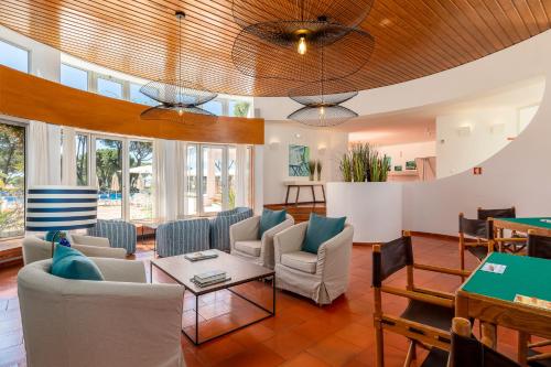a living room with couches and a table at Apartamentos Turisticos Pinhal Da Marina in Vilamoura