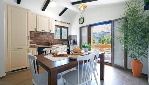a kitchen and dining room with a wooden table and chairs at Casa Valla by Rent Istria in Buzet