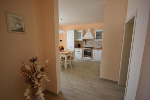 a kitchen with a table and a dining room at LA CASA DI CHIANNI La Pieve in Chianni
