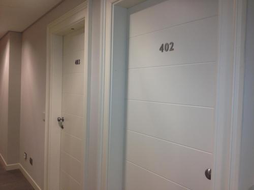 a closet with white walls and a door at Tag Hotel in Fano