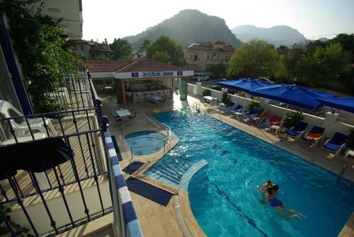 a swimming pool with a person in the water at Rota Hotel in Dalyan