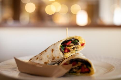 a taco on a white plate on a table at Hotel Kennedy in Lido di Jesolo