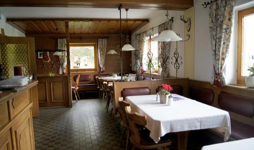 a dining room with a table and some chairs at Pension Hohe Salve in Westendorf