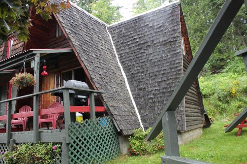 a house with a gray shingled roof at Sunny Bluffs Chalets in Kaslo
