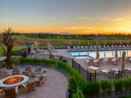 a resort with a pool and chairs and a fire pit at Pronghorn Resort in Bend