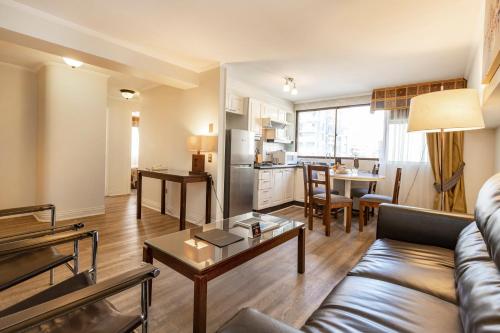 a living room with a couch and a table at Park Plaza Apartments in Santiago