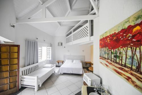Cama ou camas em um quarto em Pousada Passeio Brig Maresias