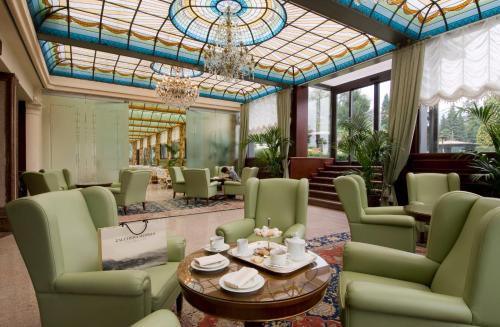 a living room filled with couches and chairs at Grand Hotel Bristol in Stresa