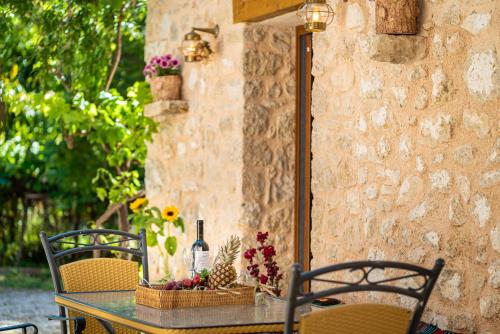 a table with flowers and a bottle of wine on it at Villa Zacharenia in Nikiana