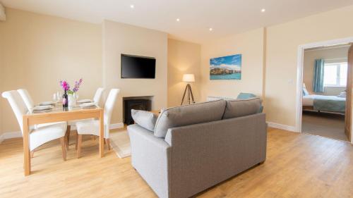 a living room with a couch and a table at Lastra Farm Hotel in Amlwch