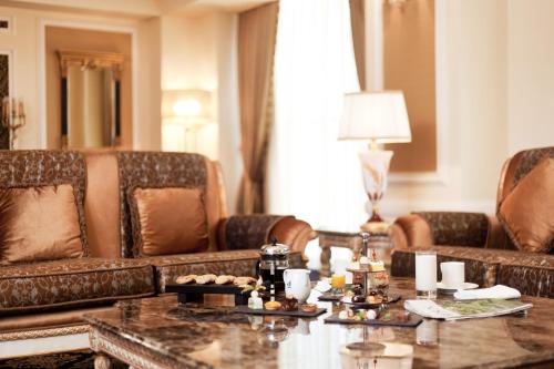 a living room with couches and a coffee table at Divan Erbil Hotel in Erbil