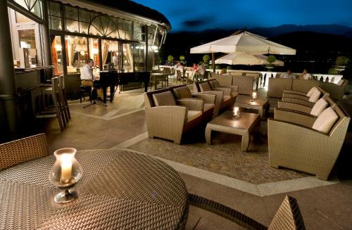 a restaurant with chairs and a table with candles at Hotel Splendid in Baveno