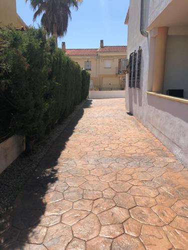 a stone walkway next to a building at Casa Pareada en Peñiscola in Peñíscola