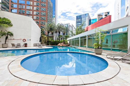 a large swimming pool in the middle of a building at You Stay at Vila Olimpia - ITC in Sao Paulo