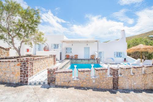 a villa with a swimming pool and a house at Starlight Luxury Seaside Villa & Suites in Imerovigli