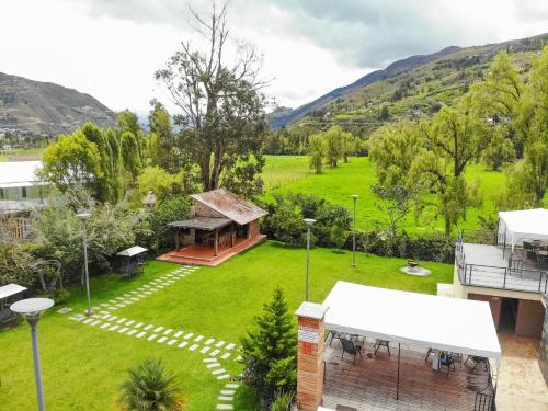 an aerial view of a yard with a house at Arhaná Hosteria & Resort in Gualaceo