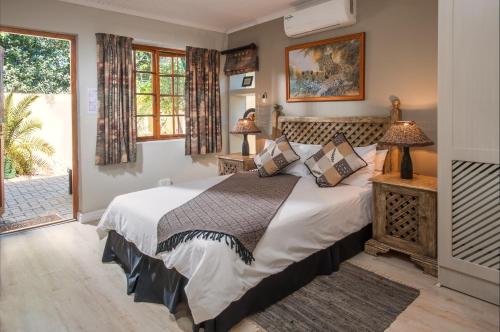 a bedroom with a large bed and a window at Algoa Guest House Summerstrand in Port Elizabeth