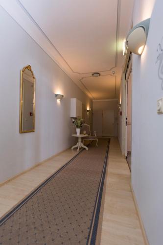 a hallway with a mirror and a table in a room at Hotel Burghof in Hof