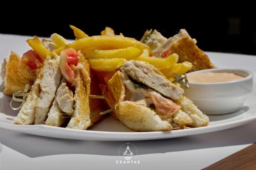 a plate of food with a sandwich and french fries at Megali Ammos House in Megali Ammos