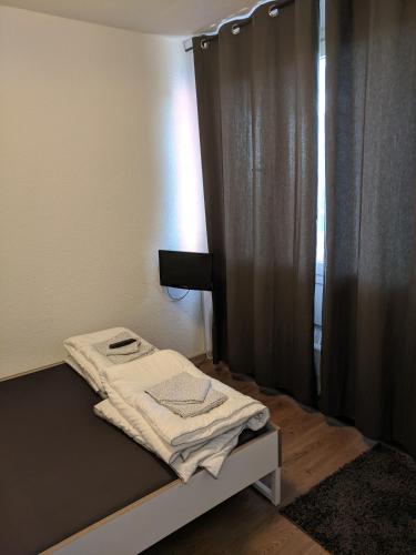 a room with a bed with a curtain and a window at FeWo Köln in Cologne
