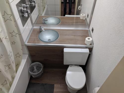 a small bathroom with a sink and a toilet at FeWo Köln in Cologne