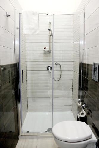 a bathroom with a glass shower with a toilet at Live Naples in Naples
