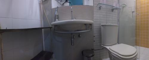 a bathroom with a sink and a toilet at Airport Pousada in Cabo Frio