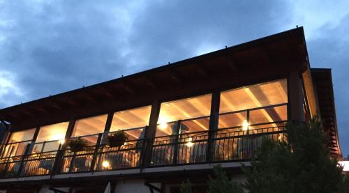 a building with large windows on the side of it at Ostello Trentapassi in Zone