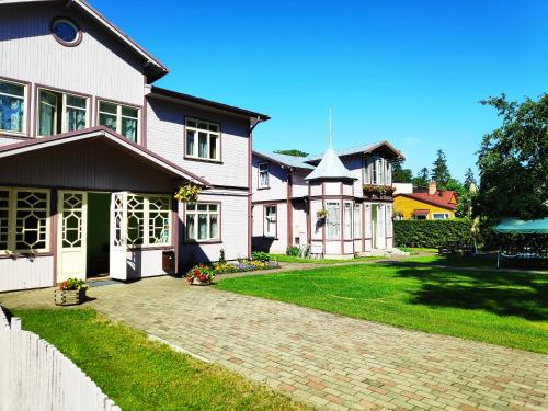 a house with a brick driveway in front of it at Elīna in Jūrmala