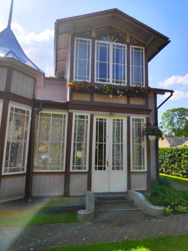 a house with white doors and windows at Elīna in Jūrmala