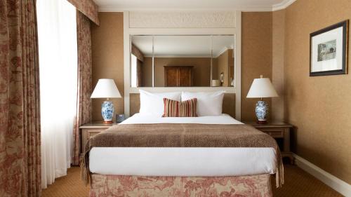 a hotel room with a bed and a lamp at Wedgewood Hotel & Spa - Relais & Chateaux in Vancouver