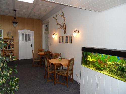 a dining room with a fish tank on the wall at Ferienappartements Rindfleisch in Stralsund
