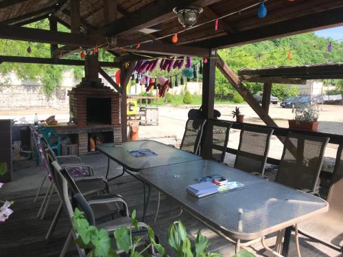a table and chairs on a patio with a fireplace at CHALET Orsova in Orşova