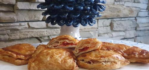 a plate with three pastries on a table at Ines bed and breakfast in Giardini Naxos