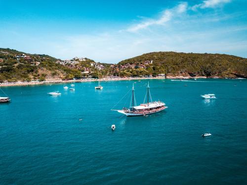 a group of boats floating in a large body of water at La Boheme Hotel e Apart Hotel in Búzios