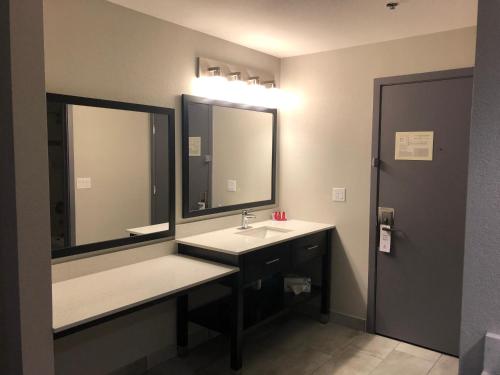 a bathroom with a sink and a large mirror at Baymont by Wyndham Moses Lake in Moses Lake