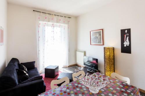 a living room with a table and a couch at Casa Laura Follonica in Follonica