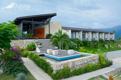 a villa with a swimming pool and a building at Gyrola Birding Hotel Boutique in La Mesa
