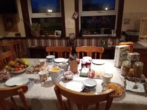 a table with a white table cloth with food on it at Antrim Heights Estate in Antrim